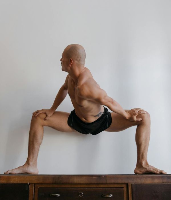 Athlete in a powerful yoga pose, demonstrating strength and balance.